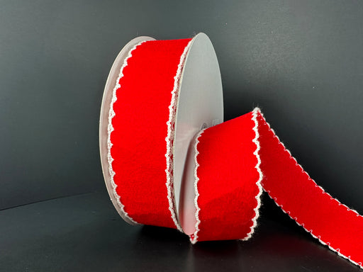 A spool of 1.5X10Y Red Felt/White Scallop Edge Unwired Ribbon (73573-09-12) stands upright against a plain black background, with a length extending outward from the roll.