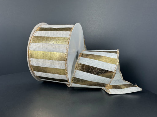A large spool of 2.5X10Y White Linen/Gold Embossed Horizontal Big Stripe Ribbon 73574-40-41 is partially unrolled on a dark surface against a dark background.