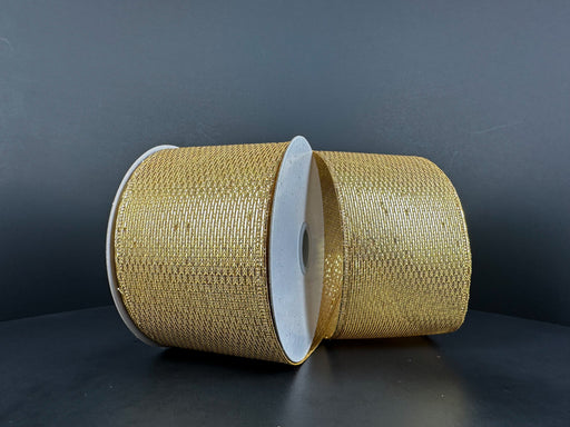 Two spools of 2.5X10Y Gold Stairstep Woven Metallic 76310-40-15 ribbon sit side by side against a dark background, their metallic surfaces showcasing detailed textured patterns.