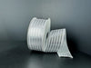 A spool of 1.5X10Y White Satin/Silver Metallic Embossed Vertical Grain Ribbon (76555-09-51) stands upright against a dark background, with a length unrolled and elegantly draped beside it.