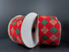 A large spool of 2.5" x 10 yard Red Velvet/Green-Gold Argyle Diamonds Ribbon (78305-40-17) sits against a dark background, bringing festive elegance to your holiday décor with its rich velvet texture and glittering plaid-inspired diamond pattern.