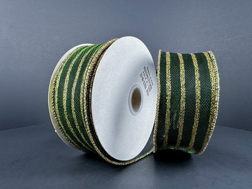 Two spools of 1.5" x 10-yard dark green metallic and gold glitter vertical stripes ribbon, upright on a dark background. The ribbons are coiled around white cylindrical cores, with one glittering ribbon slightly covering the other.