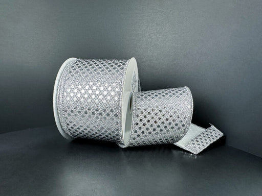 Two rolls of 2.5X10Y Silver Metallic Dragonscale Dots Ribbon (78521-40-51) are displayed on a dark background—one roll stands upright, the other lies down with shimmering ribbon featuring a diamond pattern unrolled.