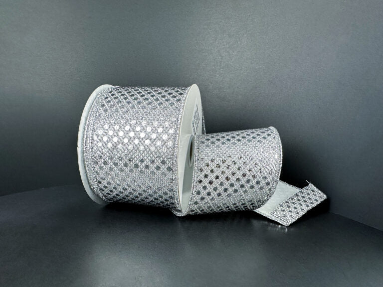 Two rolls of 2.5X10Y Silver Metallic Dragonscale Dots Ribbon (78521-40-51) are displayed on a dark background—one roll stands upright, the other lies down with shimmering ribbon featuring a diamond pattern unrolled.