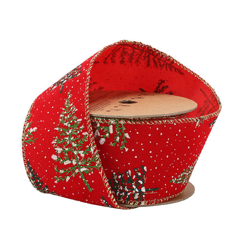 The 2.5" Red Snowy Trees Ribbon (WR-10234-063-10) features green snowy trees, white snowflakes, and gold edges on red wired ribbon, partially unrolled with the festive pattern wrapped around the spool.