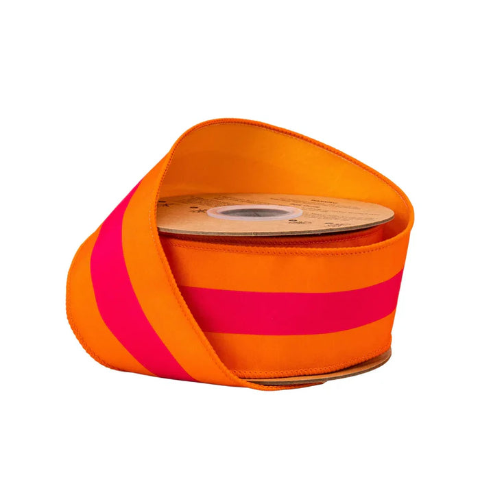The 2.5 Inch Pink on Orange Center Stripe with Orange Backing Ribbon 8217W-750-63E is shown partially unrolled, displaying its vibrant orange base and wide hot pink stripe against a white background.