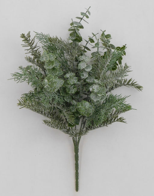 The 18 Green Iced Mixed Pine Cedar Bush 83249 is a small artificial bouquet with pine, cedar, and eucalyptus leaves dusted in glitter, arranged against a plain white background.