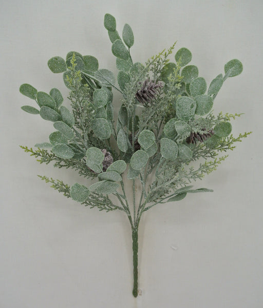 The 19 Green Eucalyptus and Cedar Spray 83662 features green artificial foliage with round, frosted leaves, cedar accents, and pinecones, arranged against a plain white background.