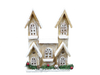 The 12 Brown House with 10 LED Lights (84014BN) features two peaked towers, white frosted accents, festive greenery with red berries and pinecones, LED illumination, and charming lattice designs on its arched and square windows.