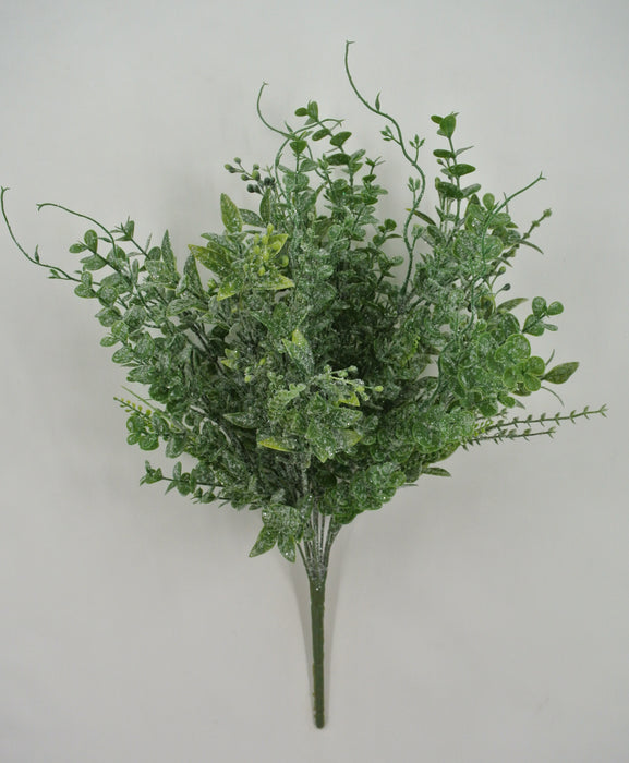 The 21" Mixed Iced Greenery Spray 85265 features frosted, snowy artificial leaves arranged in a lifelike spray, displayed against a plain light gray background.