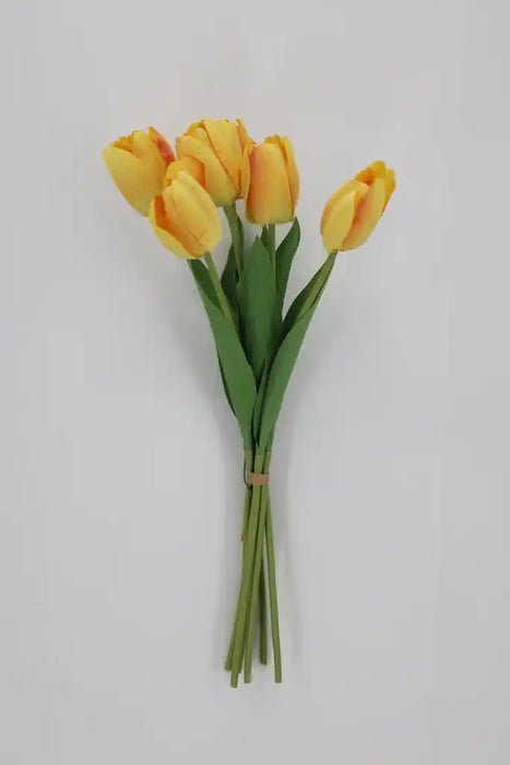 The 19 Inch Yellow Tulip Bundle with 6 Stems 85640-YEL features vibrant yellow tulips with green leaves, bound by a rubber band and displayed against a plain light background.