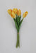 The 19 Inch Yellow Tulip Bundle with 6 Stems 85640-YEL features vibrant yellow tulips with green leaves, bound by a rubber band and displayed against a plain light background.