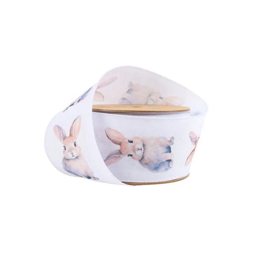 The 2.5 Inch Printed Bunny on White Ribbon 9325W-029-63E features light brown and white watercolor-style bunny illustrations, ideal for wreaths or gift wrapping, and is displayed against a plain white background.