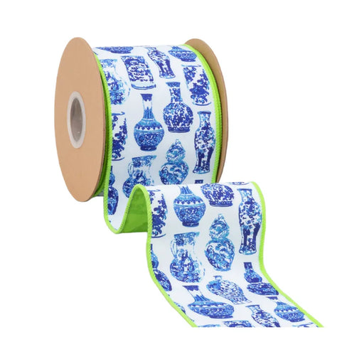 A roll of 4 Inch Blue and White China Pots with Lime Green Backing Ribbon (9373W-018-100E) featuring decorative vase patterns and a green border is partially unrolled on a white background, ideal for wreaths.