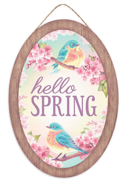 The 13Hx9L oval sign, Hello Spring with Birds, in brown, pink, turquoise, lavender, and yellow (AP7365) features vibrant birds on cherry blossom branches against a pastel background. This wooden decor piece brings cheer and celebrates the seasons beauty in any space.