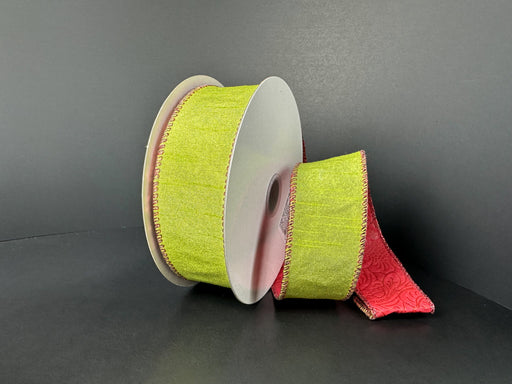 Two spools of 1.5x10y double sided lime dupioni/red glitter emboss ribbon (D73580-09-09) feature light green with red decorative edges, a red reverse embossed with a floral pattern, all shown on a black background.