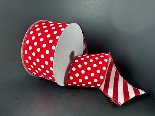 The 2.5X10Y Double Sided Red Satin-White Dots/Red-White Glitter Candy Cane Stripe Ribbon (D73581-40-12) features red satin with white polka dots and a red-and-white striped tail, displayed on a dark gray surface.