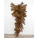 The 30 Brown Mixed Pine Teardrop with 90 Ties (DC30TDBR) features dense, downward-hanging branches and is beautifully displayed against a white wall and wooden floor.