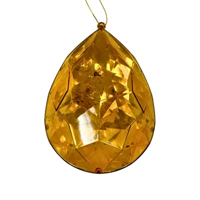 The 6.3" x 4" x 9" Amber Plastic Drop Ornament (DCORN5408AM) features faceted, teardrop-shaped plastic that reflects light beautifully, hanging from a gold string to add elegance and shine to any decor.
