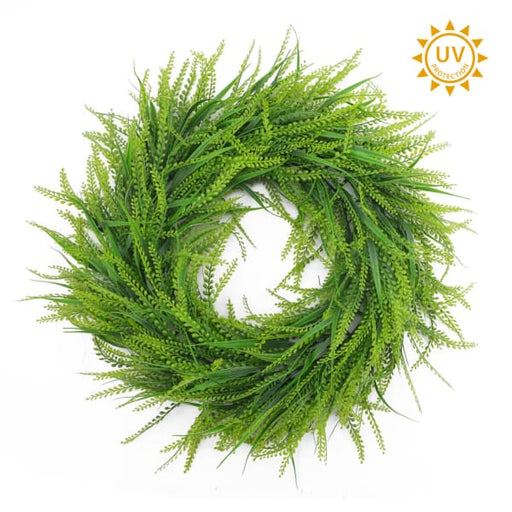 The 24" Two Tone Green Bead Grass Wreath (E66261813), made of artificial foliage with small leaves, is shown on a white background. A sun icon in the top-right highlights its UV protection.