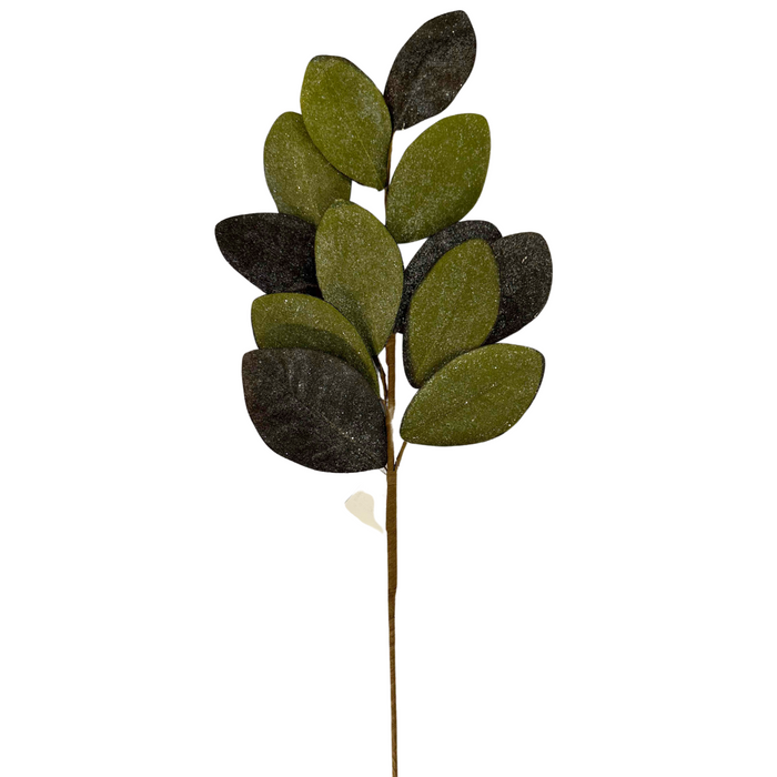 The 30" Vintage Glitter Magnolia Leaves Spray (ISB73133) showcases oval-shaped green and dark green artificial leaves with a glitter finish, layered for depth.