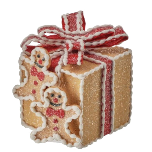 Decorative gingerbread gift with a red ribbon on a white background
