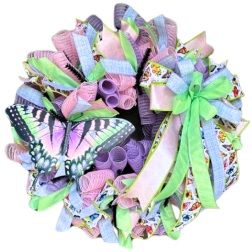 The Pastel Butterfly Completed Wreath features purple, pink, and green ribbons, a large green bow, and an eye-catching artificial butterfly. Shipping is included for your convenience.