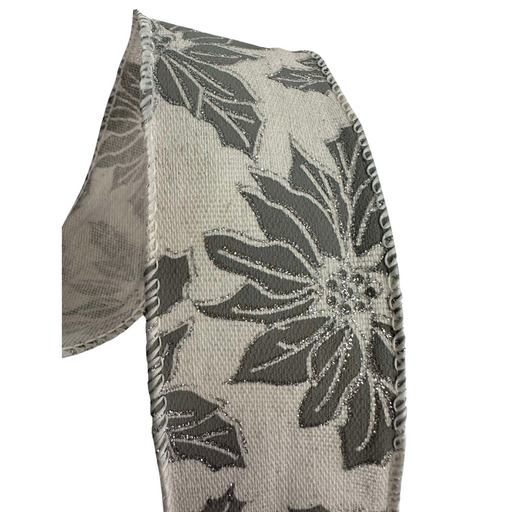 A close-up of the 2.5" Gray Burlap with Gray Poinsettia Wired Ribbon R32934 showcases a pattern of dark gray and light gray flowers with embroidered edges. The wired ribbon is slightly curved against a plain white background, adding subtle elegance with its floral design in shades of gray and silver.