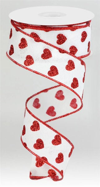 The 1.5X10Yd White and Red Small Glitter Hearts on Royal Ribbon RGA173727 features red glitter hearts and red-stitched edges, with a length that curls gracefully downward in a spiral.