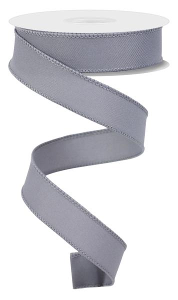 The 7/8X10Yd Diagonal Weave Grey RGE720210 ribbon unfurls in a spiral, featuring a smooth wired finish with a subtle sheen. The spool has a white cylindrical top.