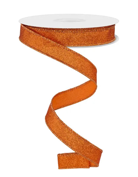 A spool of 5/8X10YD Orange Shimmer Glitter Ribbon (RGF108920) cascades in a loose spiral against a white background, highlighting its sparkling glitter accents.