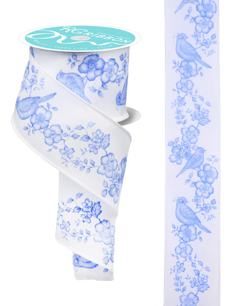 The 2.5x10yd White and Blue Chinoiserie Bird with Florals Ribbon (RGF1810WR) features a delicate bird and floral pattern printed along its length, partially unwound to showcase the detailed design.