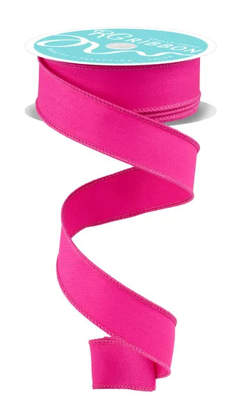 A spool of Fuchsia Diagonal Weave Ribbon (7/8" x 10 yds, RGH730507) unfurls in a spiral against a white background. The smooth ribbon has neatly finished edges and comes on a spool with a teal label.