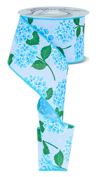 A partially unrolled spool of Light Blue Green Hydrangea Ribbon 2.5 Inches by 10 Yards (RW825614) beautifully displays blue hydrangea flowers and green leaves on a light blue background.