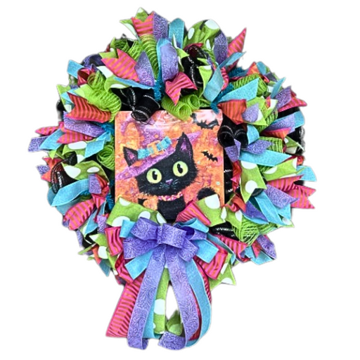 The Vibrant Halloween Cat Completed Wreath features pink, purple, green, and blue ribbons, a wide-eyed black cat in a witch hat at the center, and a purple-blue bow—perfect for your Halloween decor.
