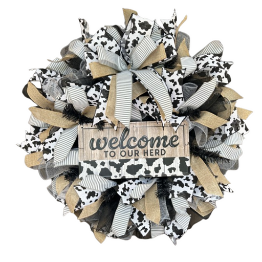 The Welcome To Our Herd Completed Wreath features black, white, and burlap cow-print ribbons with a wooden sign reading welcome TO OUR HERD, ideal for DIY fans or adding rustic charm to your space.