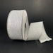 A partially unspooled roll of 1.5X10Y Silver All Flat Glitter Ribbon (X820609-16) with decorative edge is displayed against a plain black background.
