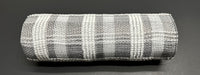 A roll of 10" Gray & White Fuzzy Plaid Mesh (XB235810-51) rests on a dark, smooth surface.