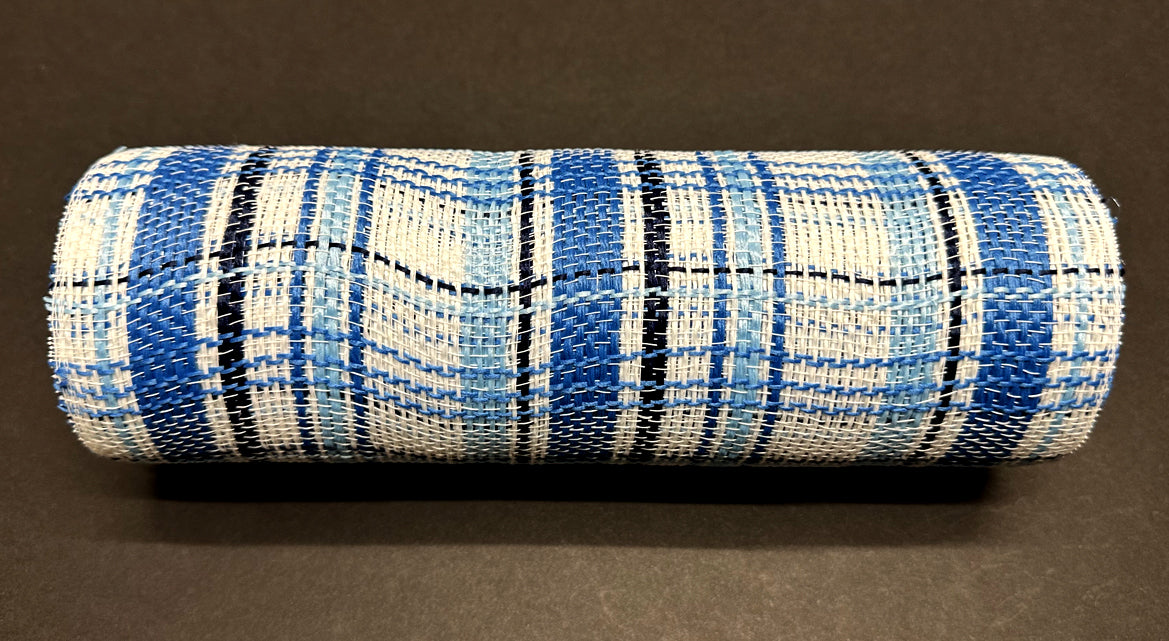 A 10x10Y roll of Navy-Lt Blue-White Fabric Plaid Mesh (XB240110-27) sits on a dark surface, displaying an intricate weave and mesh-like texture, with navy, light blue, and thin black lines.