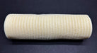 The 10X10Y Ivory Breeze Solid Mesh XB240710-18, a large beige mesh fabric roll, is placed horizontally on a black background. The tightly wound mesh features a grid-like pattern.