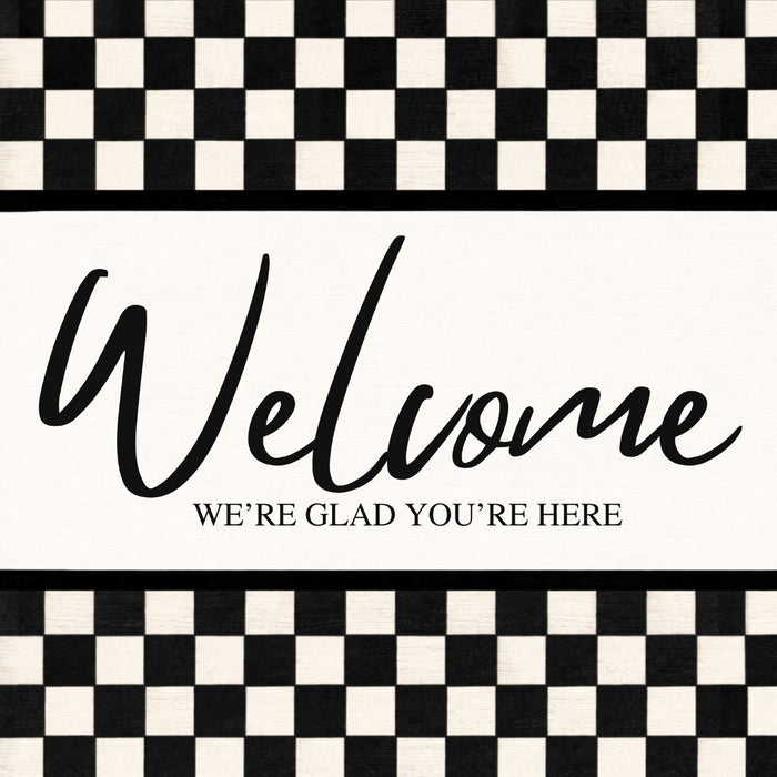 Black and white check Welcome metal sign with We’re Glad You’re Here lettering.