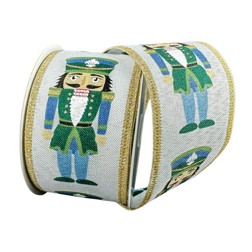 A whimsical Brown and Blue Cutesy Nutcracker Wired Ribbon (2.5 Inch x 10 Yards, 76527-40-07), featuring a charming printed nutcracker soldier design, is displayed against a plain dark background.