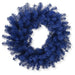 A 24" Royal Blue Artificial Pine Wreath 82295-BL, made with dark blue artificial pine branches in a classic circular form with a hollow center, is displayed against a white background.