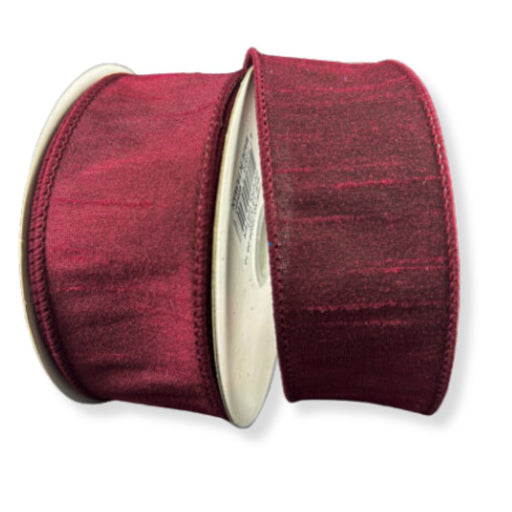 Two spools of 1.5" Burgundy Faux Dupioni Wired Ribbon (10 yards each, item 72434-09-10), featuring a deep red hue with a subtle sheen and wound on round cardboard cores, are displayed against a white background. This ribbon is ideal for elegant gift wrapping, floral arrangements, or special event décor.