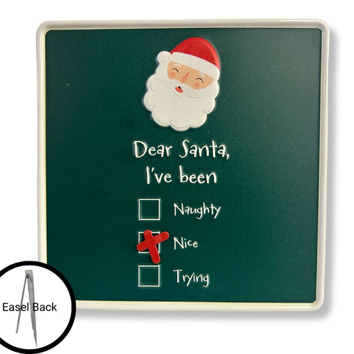 Introducing the Dear Santa Sign 4621390: a green sign board showcasing Santa’s face at the top and the phrase “Dear Santa, I’ve been” above three checkboxes—Naughty, Nice (checked with a red X), and Trying. Use the movable magnet to update your status daily. An inset image highlights the sturdy metal easel back for effortless tabletop display.