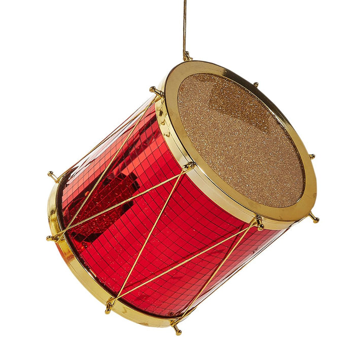 A Red & Gold Christmas Drum Ornament from the RAZ 4516726 collection hangs by a thin string, featuring sparkling gold glitter on its drumhead and gleaming gold rods along the sides—one of the festive decorations that brings classic charm to your holiday décor.