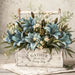 Gather Beauty Every Day 10 inch metal sign with dusty blue lilies, cream flowers and greenery in a distressed white wooden container, TTE-636.