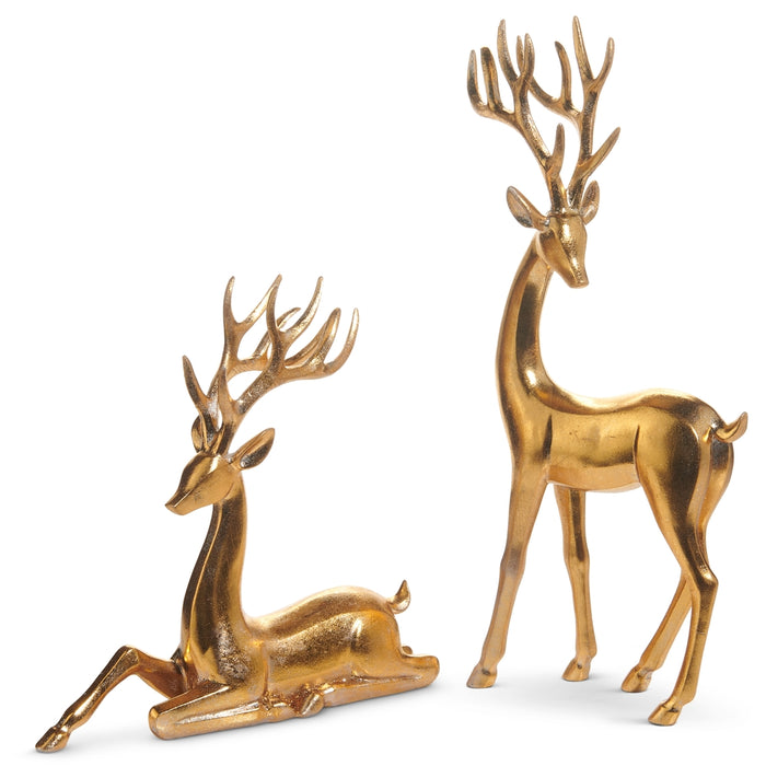 Elevate your holiday décor with the Set of 2 Gold Christmas Deer by RAZ (4512106), featuring one standing and one sitting gold reindeer figurine, each with majestic antlers—ideal for Christmas decorating or as festive gold deer accents against a white background.