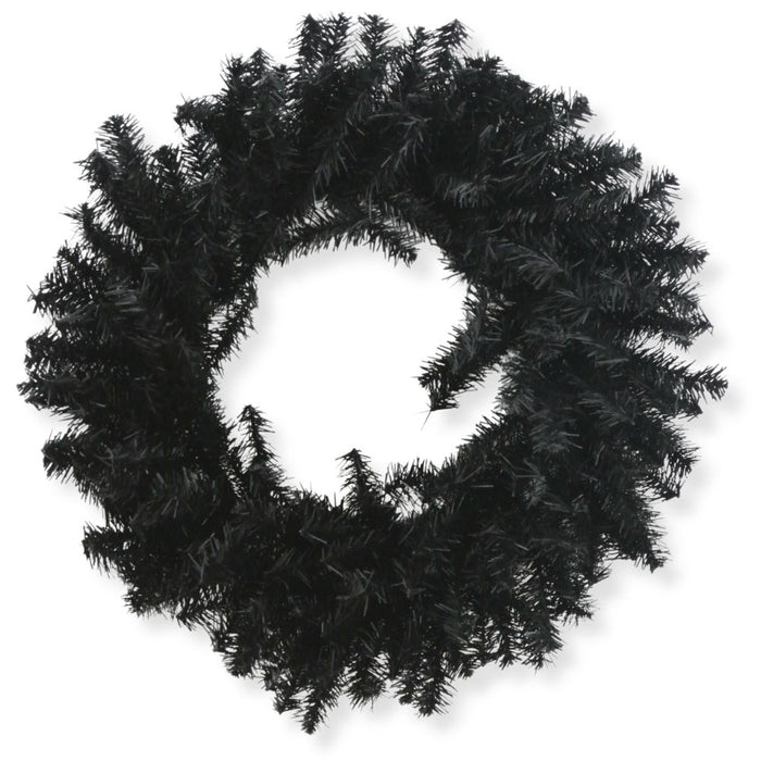 The 24" Black Artificial Pine Wreath 82295-BK features dense, spiky branches in a circular design, ideal for Halloween wreath displays or bringing a touch of gothic décor to your space. Shown against a striking white background.