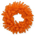 The 24" Orange Artificial Pine Wreath (82295-OR) features densely arranged, bright orange pine branches in a spiky, circular design, making it the perfect accent for your fall décor against a crisp white background.